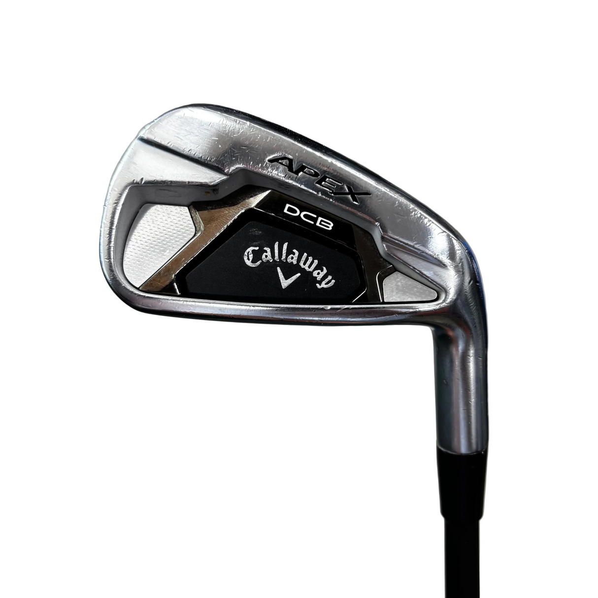 A Callaway Apex DCB iron golf club head shown in a close-up shot, standing upright on a black shaft. The Callaway and Apex DCB branding are clearly visible on the clubface.