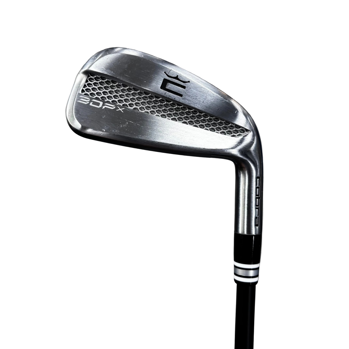 A close-up of a golf iron club head and part of the shaft, photographed on a concrete floor. The club face shows the brand mark '36' and the model 'R1'.