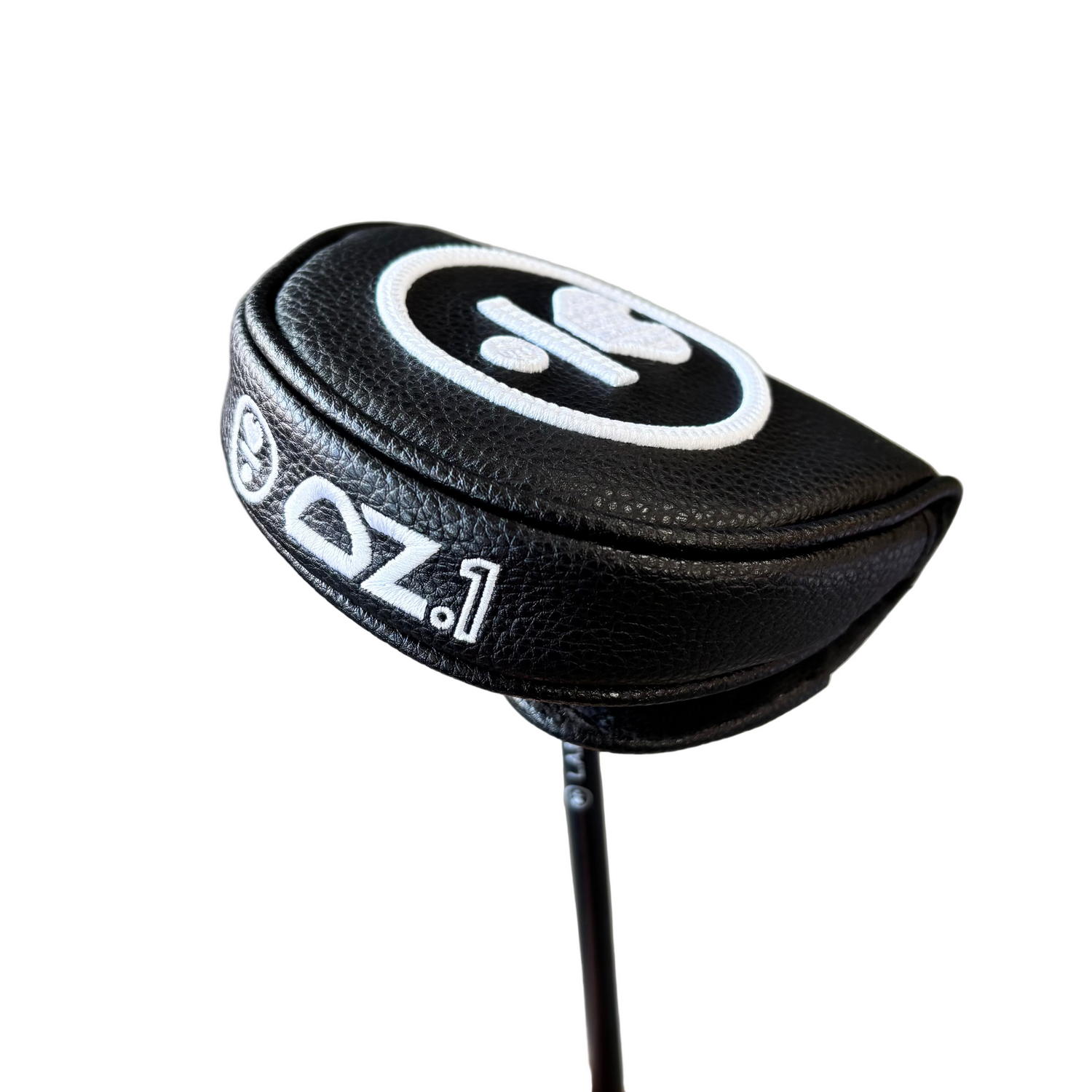Close-up of a golf club head cover with a black and white design on a blurred background