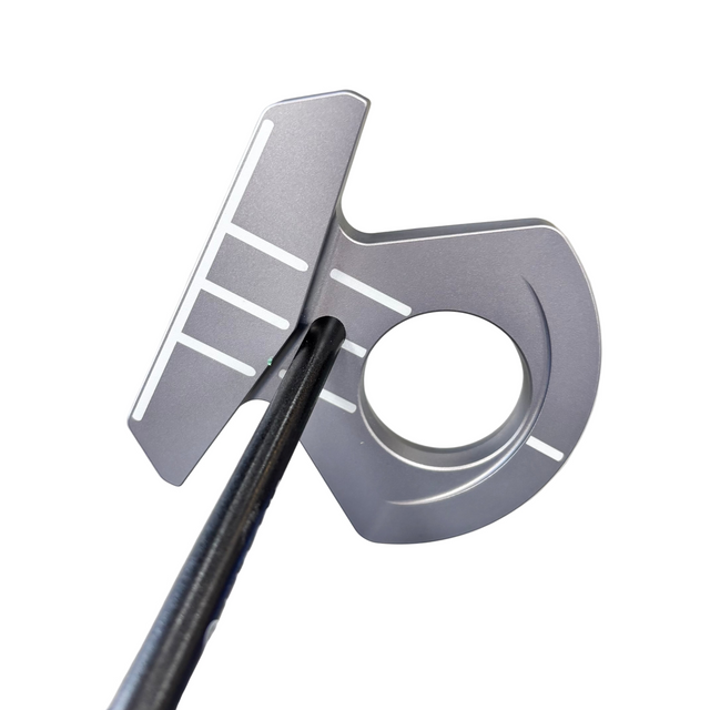 Metallic object with a cylindrical center and slotted design on a reflective surface