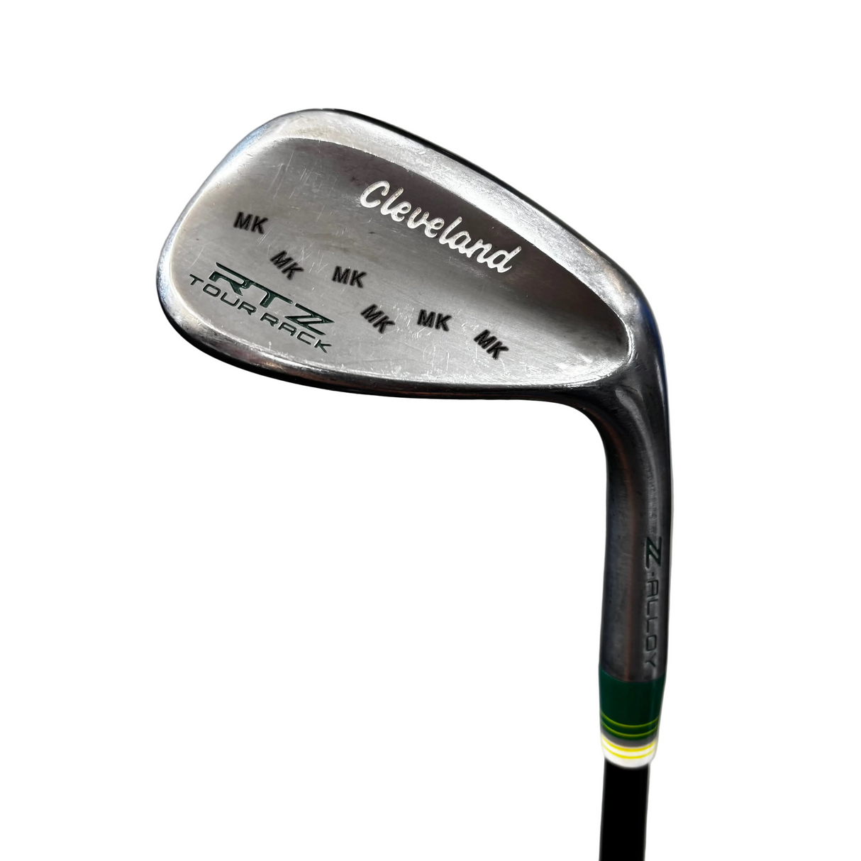 A close-up of a Cleveland RTZ  golf iron head, showing the clubface, brand engravings, and part of the shaft against a gray concrete background.