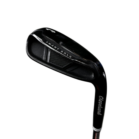 A close-up of a Cleveland Smart Sole golf iron club head, showing the brand name and model text on the black metal clubface, photographed against a gray concrete floor.