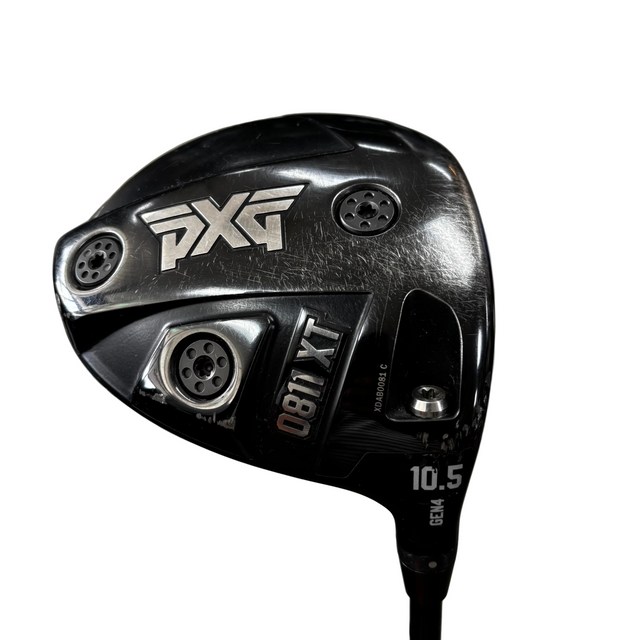 Close-up of a PXG 0811 XT  golf driver clubhead on a concrete floor, with PXG branding and model text clearly visible.