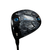 A close-up of a Paradyne A1 Smoke golf club head on a stand, featuring a textured black and gray pattern with blue accents and visible Cleveland brand logos in the blurred background.