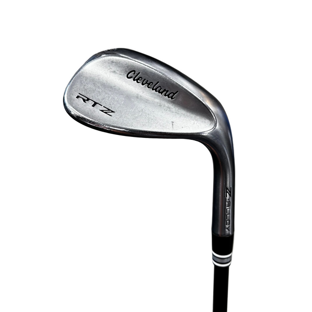 A Cleveland RTZ Z-Boost golf iron club head and part of the black shaft, photographed on a gray concrete floor.