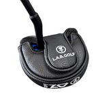 Close-up of a golf putter with L.A.B. Golf branding on a concrete floor.
