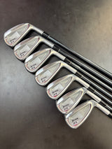 Set of golf clubs on a dark surface