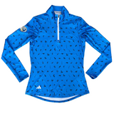 Blue long-sleeve athletic shirt with black pattern on a gray surface