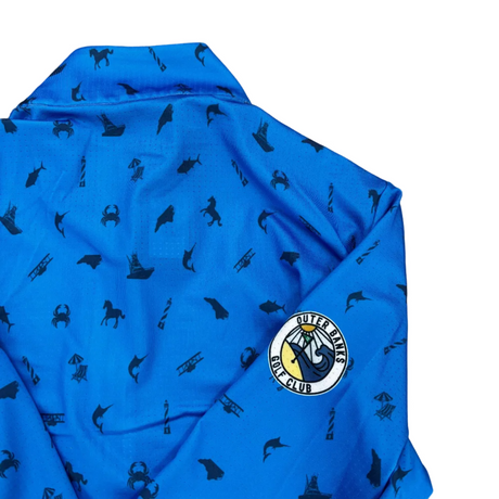 Blue fabric with black patterns and a logo on a gray concrete surface