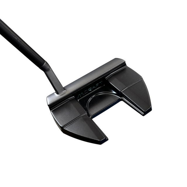 Close-up of a black golf putter on a concrete floor with blurred background