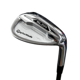 Golf club head with TaylorMade logo on a blurred background