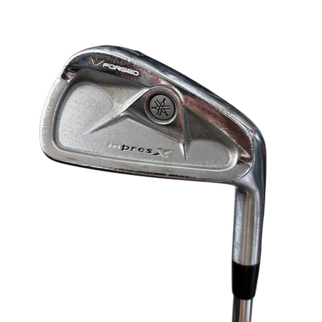 Golf club head with 'V Forged' and 'impress X' branding on a blurred background