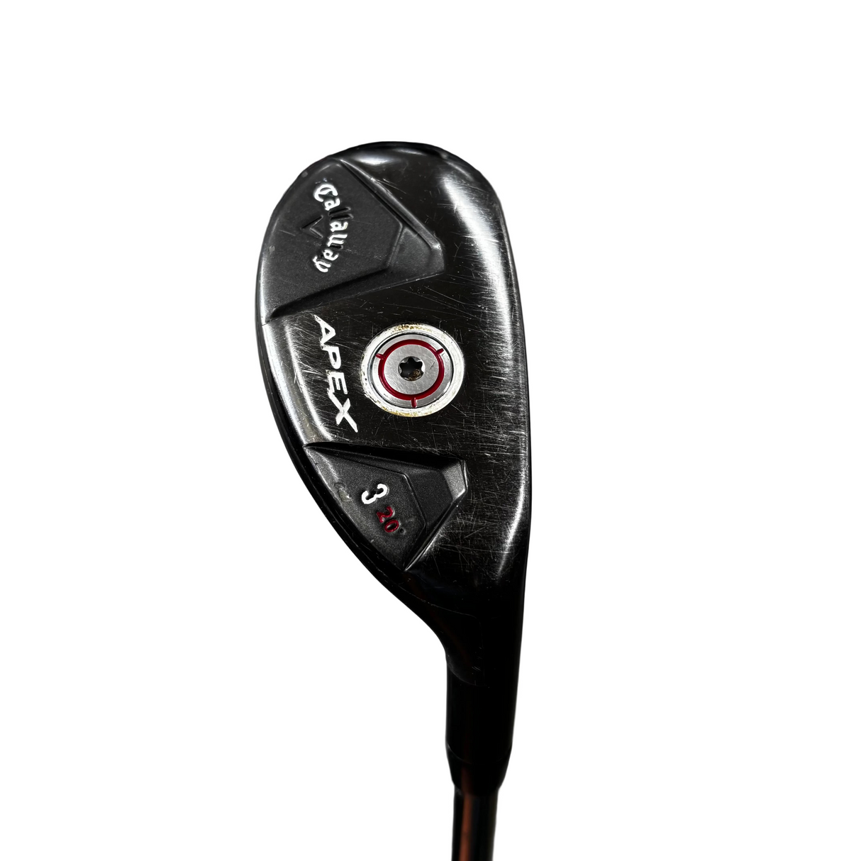 A close-up of a black Apex 3-wood golf club head with white and red branding details, standing on a stand in a golf shop with a concrete floor and bags in the background.