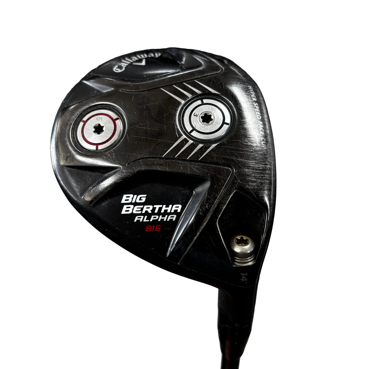 A Callaway Big Bertha Alpha B16 golf club head photographed close-up in what appears to be a store or garage setting, with the club head dominating the frame and a blurred concrete floor in the background.