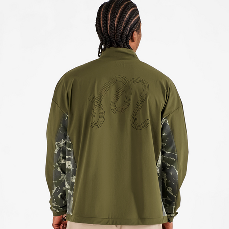 Person wearing a green long-sleeve shirt with camouflage sleeves on a white background