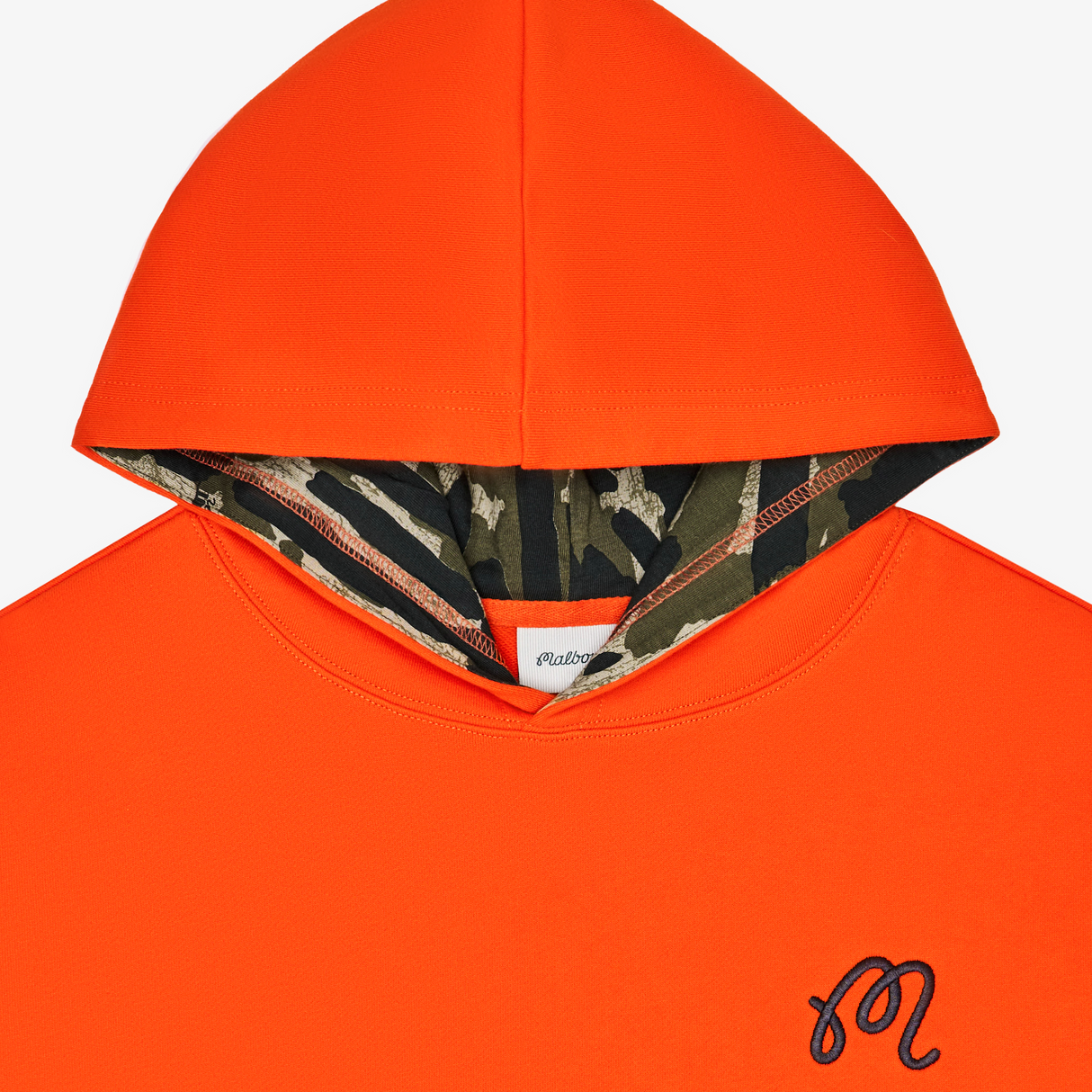 Orange hoodie with camouflage lining on a white background