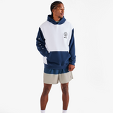Person wearing a blue and white hoodie with beige shorts on a white background