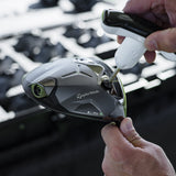 Close-up of a golf club head with a TaylorMade logo, held by a person.