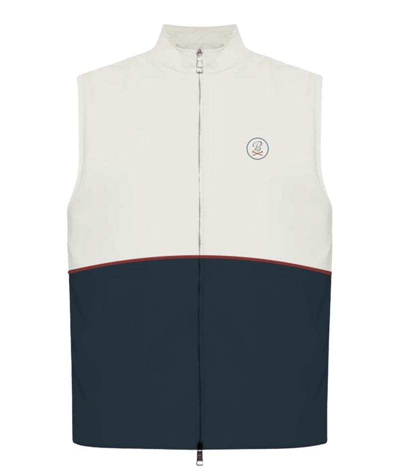 A sleeveless zip-front vest with a color-block design, featuring an off-white upper section, a dark navy lower section, and a thin red stripe separating the two sections. It has a small circular embroidered logo on the left chest.