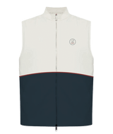 A sleeveless zip-front vest with a color-block design, featuring an off-white upper section, a dark navy lower section, and a thin red stripe separating the two sections. It has a small circular embroidered logo on the left chest.
